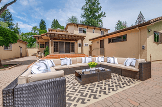 Santa Clara Airbnb staging: Outdoor patio with sectional sofa and coffee table. Complete home furnishing package overview.