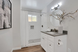 Bathroom with shower, sink, and decorative elements