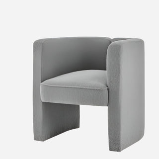 A beige Ariela Fabric Accent Arm Chair with a boucle texture, featuring a sculpted silhouette and sweeping track arms.