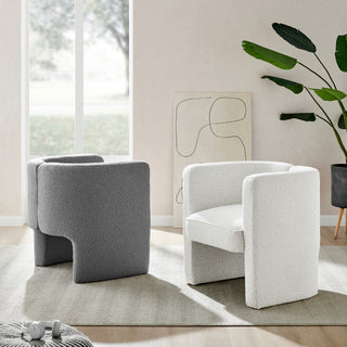 A beige Ariella Fabric Accent Arm Chair with a boucle texture, featuring a sculpted silhouette and sweeping track arms White And black setup.