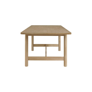 A beige Bloomfield dining table with a butterfly extension, made of wood, with rounded corners and tubular full table.