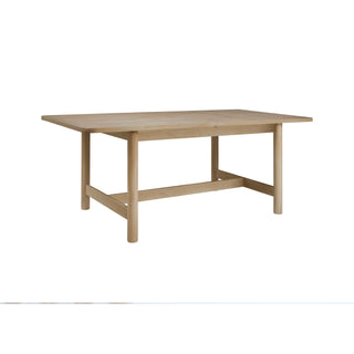 A beige Bloomfield dining table with a butterfly extension, made of wood, with rounded corners and tubular hight.