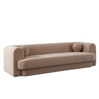 A beige camel performance velvet sofa with two accent pillow balls.