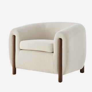 A beige fabric accent arm chair with solid wood frame and dark wooden legs.