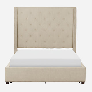 A beige upholstered queen platform bed with button tufting and nailhead accents, shown with a white mattress on it.