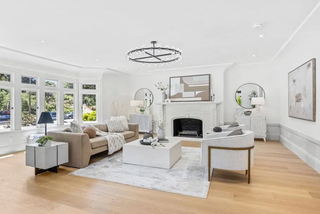 Modern living room with white walls, wooden floor, and stylish furniture.