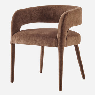 A brown velvet dining chair with a sleek, modern design and wooden legs.