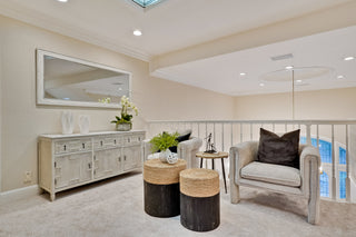 Living room with a gray armchair, side table, and decorative items.