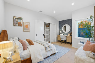 Modern bedroom with a bed, side tables, and a desk.