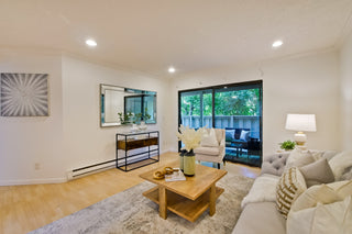Modern living room with a couch, coffee table, and decorative elements.