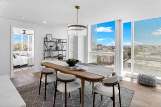 Modern dining room with a large window view of a cityscape