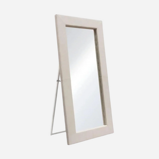 A free-standing mirror with a sand linen wrapped frame, featuring a locking easel mechanism.