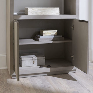 A gray Oxford bookshelf with two open doors revealing shelves with books and storage boxes.