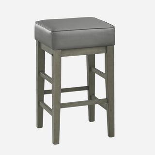 A gray faux leather counter-height stool with antiqued gray finished wood frame, square seat, and a backless design.