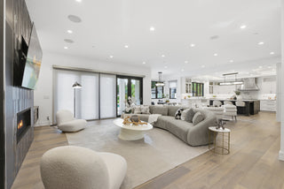 A modern living room featuring a cozy fireplace and stylish couches arranged for comfort and relaxation.
