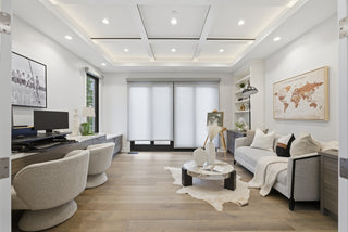 A modern living room featuring white walls and wooden floors, creating a bright and airy atmosphere.