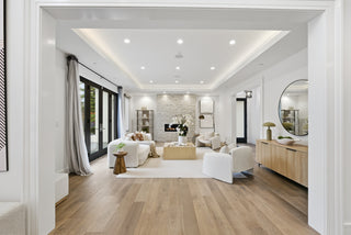 A modern living room featuring white walls and wooden floors, creating a bright and inviting atmosphere.