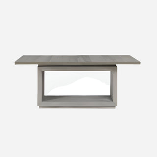 A rectangular dining table with a mineral grey finish and a sleek contemporary design, featuring top-mounted nickel-plated pulls and a floating plinth base.