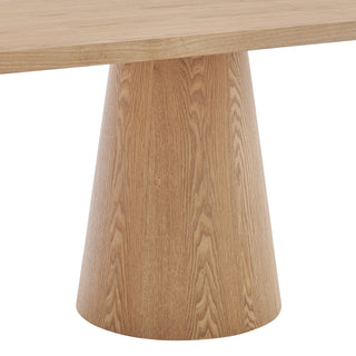 A rectangular dining table with a natural wood finish and two cylindrical pedestal bases lags