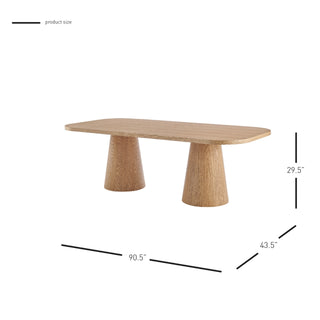 A rectangular dining table with a natural wood finish and two cylindrical pedestal bases set hight. 