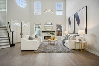 A_room_with_white_furniture_and_a_staircase_showcasing_a_clean_and_contemporary_design