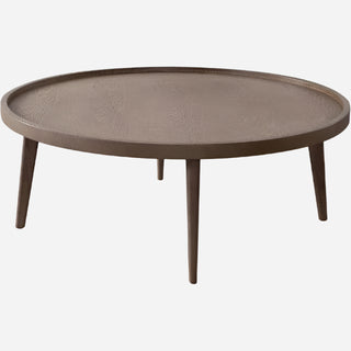 A round cocktail table with a rich almond oak finish and slender legs, placed against a white background.