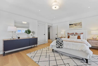 Modern bedroom with a bed, dresser, and decor