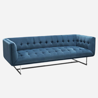 A tufted royal blue velvet sofa with a polished stainless steel frame.