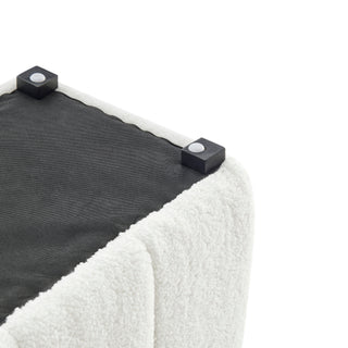 A_white_faux_shearling_bench_with_a_channeled_pattern_and_high-density_foam_padding_Lages_and_fabrics_.