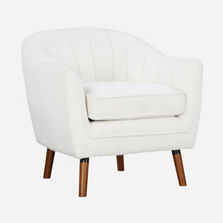 A white upholstered accent chair with channel-tufted backrest, brown-finished solid wood legs, and a removable seat cushion.
