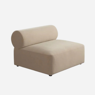 An armless chair with a light camel and ivory velvet fabric.