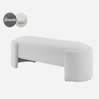 An oval-shaped fabric bench with a smooth, soft texture in a light color, likely white or light gray.