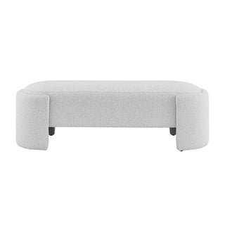 An oval-shaped fabric bench with a smooth, soft texture in a light color, likely white or light gray Font  Site.