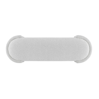 An oval-shaped fabric bench with a smooth, soft texture in a light color, likely white or light gray Full setup