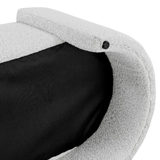 An oval-shaped fabric bench with a smooth, soft texture in a light color, likely white or light gray lag's