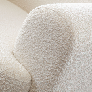 An oversized white accent-chair with attached seat and back cushions, upholstered in a luxurious fabric- designed for comfort and style.