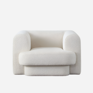 An oversized white accent chair with attached seat and back cushions, upholstered in a luxurious fabric, designed for comfort and style.