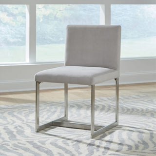An upholstered dining chair with a gray backrest and seat, featuring a brushed stainless steel frame.