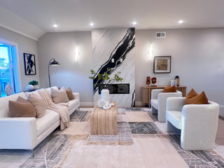 Modern Attractive living room with white furniture, decorative pillows, and a marble accent wall.
