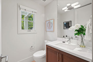 Bathroom with a sink, mirror, and window