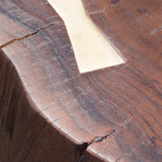 Close-Up of Rustic Solid Wood Table Surface with Natural Grain, Edge Crack, and Brass Butterfly Inlay
