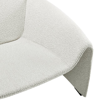 Close-up of cream textured chair with curved arm detail.