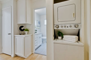 Laundry room with washer, dryer, and cabinets