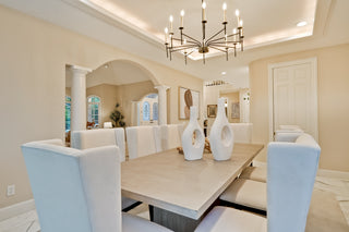 Dining room with a table, chairs, and decorative vases.