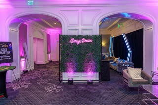 Decorative screen with 'Always Dream' text in a stylish room with purple lighting.