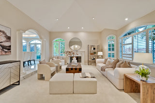 Modern living room with beige furniture and large windows
