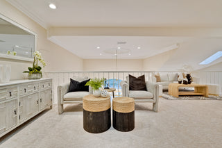 Modern living room with gray sofa, wooden coffee table, and decorative items.