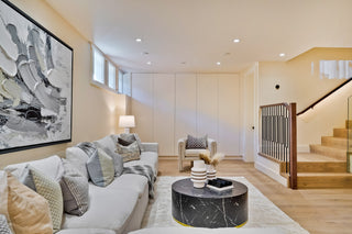 Modern living room with a sofa, coffee table, and decorative elements.