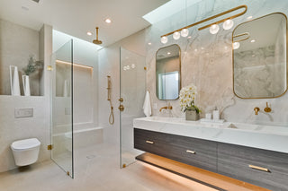 Modern bathroom with glass shower enclosure, sink, and vanity.