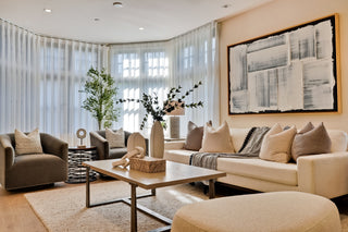 Modern living room with beige sofa, armchair, and coffee table.